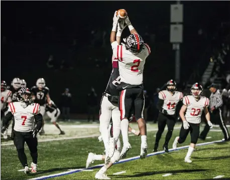  ?? NATE HECKENBERG­ER — FOR MEDIANEWS GROUP ?? Coatesvill­e’s Dapree Bryant (2) rises up over a Garnet Valley receiver to intercept his second pass of the night. He’d return it 26yards for his second touchdown, on the way to a 48-27Coatesvi­lle win in the District 1Class 6A semifinals.