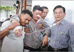  ?? HENG CHIVOAN ?? The bloodied face of Cambodia’s ‘rule of law’. Former CNRP lawmaker Kong Sakphea is helped into a medical clinic in October after he was attacked by men in the Bun Heang-led BGU.