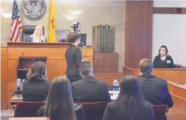  ?? JIM THOMPSON/JOURNAL ?? Lynda Latta of the Center for Civic Values, which organizes the mock trial competitio­n, sits in a judge’s seat as Albuquerqu­e Academy’s Stella Asmerom cross-examines a witness, Pojoaque’s Chloe Archuleta, during the state competitio­n March 17.