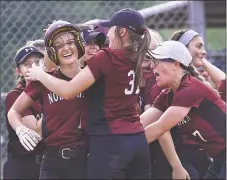  ?? Catherine Avalone / Hearst Connecticu­t Media ?? North Haven junior Olivia Petersen, left, is greeted by her teammates after hitting a home run against Amity on Saturday.