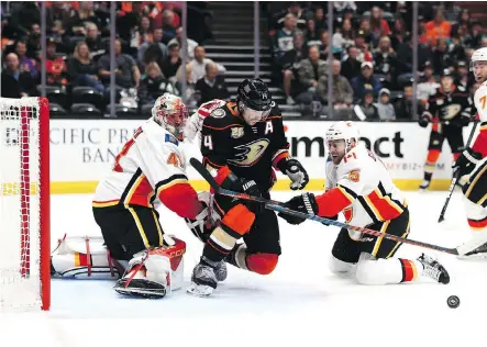  ?? SEAN M. HAFFEY/GETTY IMAGES ?? Calgary Flames goaltender Mike Smith has to deal with a cluster of players in front of his net during Wednesday’s 3-2 loss to the Anaheim Ducks. Smith’s 3.66 goals against average is the second-worst in the league.