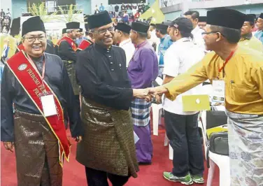  ??  ?? Warm welcome: Ibrahim (left) and Zainuddin at the Perkasa AGM where the latter was awarded the ‘Bintang Perkasa’.