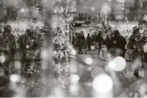  ?? Emily Elconin / Bloomberg ?? Customers shop for holiday decoration­s at Bronner’s Christmas Wonderland store in Frankenmut­h, Mich.