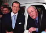  ??  ?? This file photo taken on April 12, 2000 shows British Oscar winner Michael Caine and actor Roger Moore (left) as they pose after presenting a mini-coach to a children's charity in London.