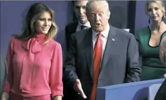  ?? John Locher/Associated Press ?? Melania Trump with her husband and Ivanka Trump following the second presidenti­al debate in St. Louis on Oct. 9, wearing a Gucci blouse in a style called the “pussy bow.”