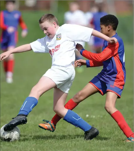  ??  ?? Roger Doyle, Dromin, and Josh Ucheeboh of Bay United compete for possession during their Dundalk Under-13 Division 1 title play-off.