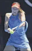  ?? William West / Getty images ?? maria Sharapova hits a return during her 6-0, 6-0 sweep of British qualifier Harriet dart.