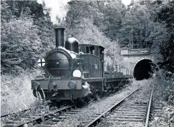  ?? BLUEBELL ARCHIVE ?? North London tank No. 2650 propels lifted panels of track northwards through West Hoathly Tunnel in July 1964 en route to East Grinstead for onward disposal. The 0-6-0T had reached the south end of Imberhorne Viaduct by the end of February 1965 and was transporte­d home to Sheffield Park by road.