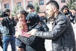  ?? [AP PHOTO] ?? A Turkish man helps a Syrian woman carrying a wounded Syrian girl to a hospital in Kilis, Turkey. An air strike Monday in the northern Syrian province of Idlib destroyed a makeshift clinic supported by an internatio­nal aid group, killing and wounding...