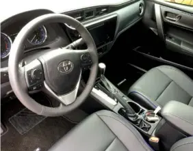  ?? STAFF PHOTO BY MARK KENNEDY ?? The interior of our Toyota Corolla tester is comfortabl­e and functional.