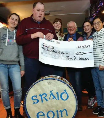  ??  ?? Carla Osterholz, Tomás Ferriter, Lotte Meier, Christoph Jensen, Adeline Fehey-Palma and Karen Lau of the Dingle Camphill Communiity with a cheque for 600 euro which was donated by the Sráid Eoin Wren at their ball night in the Barrack Height pub on Friday. Photo by Declan Malone