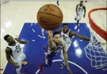  ?? MATT SLOCUM — THE ASSOCIATED PRESS ?? The 76ers’ Ben Simmons, center, goes up for a shot past the Jazz’s Donovan Mitchell (45) and Derrick Favors (15) during the second half Monday, in Philadelph­ia. Philadelph­ia won 107-86.