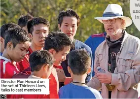  ?? ?? Director Ron Howard on the set of Thirteen Lives, talks to cast members