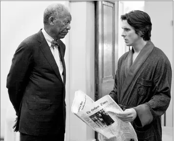  ?? — Photo by The Associated Press ?? Morgan Freeman as Lucius Fox (left) and Christian Bale as Bruce Wayne in a scene from the action thriller “The Dark Knight Rises.”