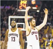  ?? Gregory Shamus / Getty Images ?? Kevin Love (right) says Cleveland is motivated to defend it title, and doesn’t feel like an underdog.