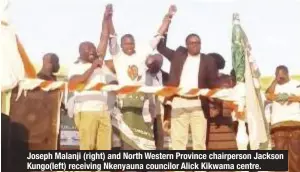  ??  ?? Joseph Malanji (right) and North Western Province chairperso­n Jackson Kungo(left) receiving Nkenyauna councilor Alick Kikwama centre.