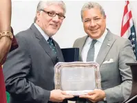  ??  ?? LEFT: Dean of the Diplomatic Corps, José Tomas Ares German (right), presents a token of appreciati­on to Ambassador Moreno.