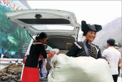  ?? PHOTOS BY JIANG HONGJING / XINHUA ?? Members of the first group of Atuleer households moving from the mountain village to apartments in the Zhaojue county seat pack items for their new homes on May 12.