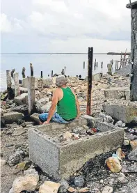  ??  ?? Left: A man walks among the destructio­n at Phillipsbu­rg Town Beach in the Dutch Caribbean island of St Maarten. Right: surveying the remains of a destroyed restaurant in the Cuban town of Isabela de Sagua.
