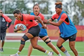  ?? Photo: World Rugby ?? Fijiana’s Ana Maria Naimasi (with ball) escapes a tackle by Aloesi Nakoci (right) and Talei Wilson (centre) during the team’s training session prior to the HSBC SVNS at Dignity Health Sports Park on February 29, 2024 in Los Angeles, United States.