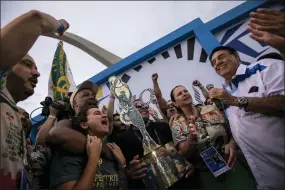  ?? BRUNA PRADO — THE ASSOCIATED PRESS ?? Members of Imperatriz Leopoldine­nse samba school celebrate after receiving the top trophy for the best samba school parade during Carnival celebratio­ns at the Sambadrome in Rio de Janeiro, Brazil, Wednesday, Feb. 22, 2023.