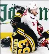  ??  ?? Washington Capitals defenseman Nick Jensen (3) tangles with Boston Bruins center Brad Marchand (63) during the third period of an NHL hockey game, on March 3, in Boston. (AP)