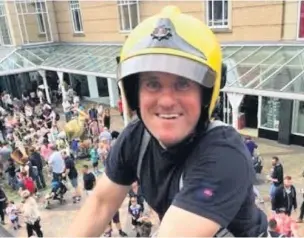  ??  ?? ●●Firefighte­r Lee Markham at the Merseyway ladder climb