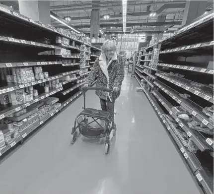  ?? CHRIS HELGREN • REUTERS ?? A shopper walks through an aisle at a Loblaws supermarke­t in Toronto in March.