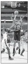  ?? AP/CHARLES REX ARBOGAST ?? Connecticu­t’s Napheesa Collier (24) puts up a shot in front of DePaul forward Chante Stonewall and Deja Cage during the top-ranked Huskies’ 103-69 victory Friday at Wintrust Arena in Chicago. Collier finished with 17 points as the Huskies gave Coach...