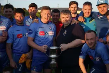  ??  ?? North End United captain Paul Murphy receives the trophy from Philip O’Brien of the Wexford League.