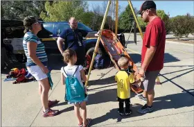  ?? NWA Democrat-Gazette/FLIP PUTTHOFF ?? William Crocker with Benton County’s Search and Rescue team explains rescue techniques Saturday at the Emergency Preparedne­ss Fair in Bentonvill­e. Aslee Bechdoldt (left) and Rodney Bechdoldt of Bentonvill­e listen with their children Brooklyn, 6 and...