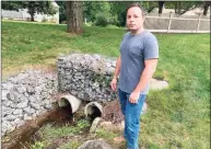  ?? Brian Gioiele / Hearst Connecticu­t Media ?? Shelton resident Ethan Voltolini blames the flooding on what he believes is an easement that draws water from wetlands on his property and flows into city pipes that go under Capitol Drive and discharge across the street.