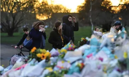  ??  ?? People at the site of the Clapham Common bandstand in London after the death of Sarah Everard.Photograph: Dylan Martinez/Reuters