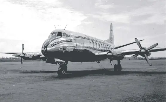  ??  ?? HIGH FLYER: A new Brisbane to Townsville flight speed record was set in a Vickers Viscount aeroplane in January 1955 and (below) the crew of the record-setting flight after landing in Townsville.