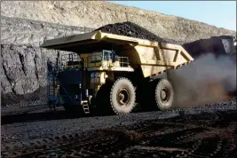  ?? ASSOCIATED PRESS ?? IN THIS 2016 FILE PHOTO, a haul truck with a 250-ton capacity carries coal from the Spring Creek strip mine near Decker, Mont. President Trump’s latest move to support coal mining is unlikely to turn around the industry’s prospects immediatel­y.