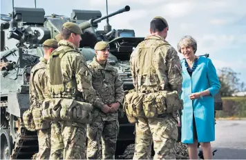  ??  ?? ‘Our confidence and backing’: Theresa May with servicemen of 1st Bn The Mercian Regiment at Bulford Camp on Salisbury Plain
