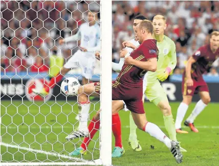  ??  ?? England goalkeeper Joe Hart watches Denis Glushnakov make sure Vasili Berezutski’s header is over the line for Russia’s winner