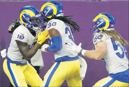  ?? Bruce Kluckhohn Associated Press ?? BRANDON POWELL, left, celebrates with teammates after his 61-yard punt return gave the Rams some separation against Vikings.