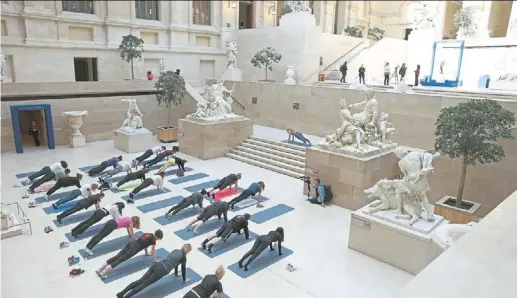  ?? — photos: afp ?? people take part in a rehearsal of ‘les Visites Sportives’, an experience proposed by artist and choreograp­her Mehdi Kerkouche in the Cour Marly at the louvre museum.