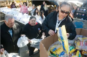  ?? RECORDER PHOTOS BY CHIEKO HARA ?? Volunteer Rachel Mosqueda sorts donated items Thursday at the 44th annual El Granito Foundation Food Basket Giveaway.