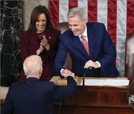  ?? THE ASSOCIATED PRESS ?? President Joe Biden shakes hands with House Speaker Kevin McCarthy of Calif., as he arrives to deliver the State of the Union address to a joint session of Congress at the U.S. Capitol Tuesday in Washington. Vice President Kamala Harris applauds at left.