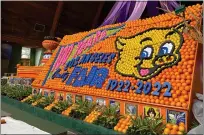  ?? DAVID ALLEN — STAFF ?? Oranges, lemons and limes make up this throwback display in the Flower and Garden Pavilion of the L.A. County Fair. That’s Thummer, the fair’s cheerful pig mascot. The fair is marking 100years.