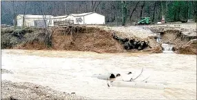  ?? PHOTO BY PATRICK WING ?? Two days after heavy rains forced Patrick Wing and his family to evacuate their home along Bear Hollow Creek, Wing returned to find that his driveway was washed out by the flood.
the rains the weekend after Christmas.