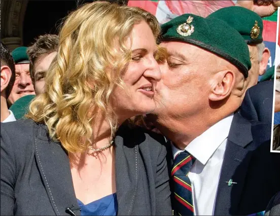  ??  ?? Victory at last: A former Marine kisses Sgt Blackman’s wife Claire on the cheek amid the celebratio­ns yesterday