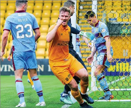  ??  ?? LION ROARS: Livingston defender Alan Lithgow celebrates after nodding in the final goal of the day from close range