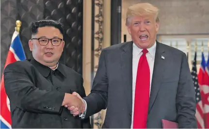  ?? Photo: AFP ?? North Korean leader Kim Jon-un and US President Donald Trump shake hands following a signing ceremony at their historic summit in Singapore.