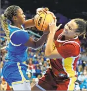  ?? ?? UCLA’S CHARISMA OSBORNE, left, and USC’s McKenzie Forbes battle for a first-half rebound.