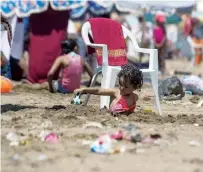  ?? AFP file ?? A child plays on the beach in Rabat. Activists blame lack of awareness for increasing water pollution.—