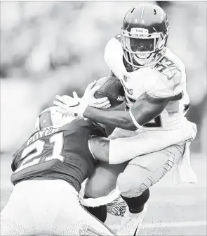  ?? ADRIAN KRAUS THE ASSOCIATED PRESS ?? Buffalo Bills free safety Jordan Poyer applies a tackle on Tennessee Titans running back Dion Lewis during the second half Sunday in Orchard Park, N.Y. The Bills won, 13-12.