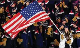  ?? HARRY HOW / GETTY IMAGES ?? U.S. flag bearer Erin Hamlin, who competes in the luge, leads her team during the opening ceremony of the Pyeongchan­g Games.